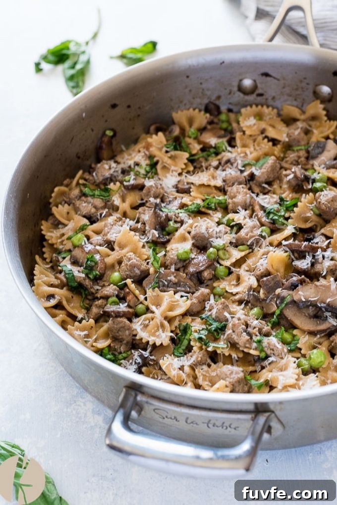 Italian sausage bow tie pasta in a skillet