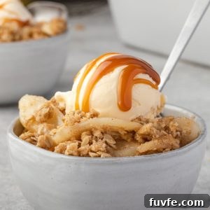 Warm Pear Crumble Recipe with Cinnamon Oat Topping 10 Pear crumble in a bowl with ice cream and caramel