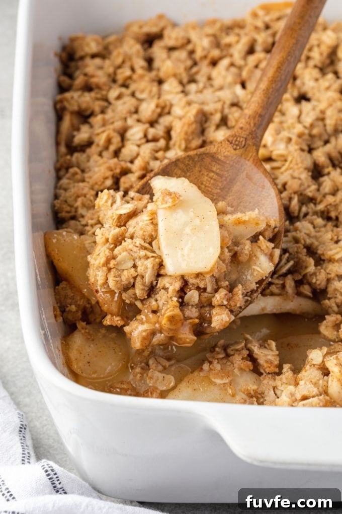 Warm Pear Crumble Recipe with Cinnamon Oat Topping 3 Spoonful of pear crumble over baking dish