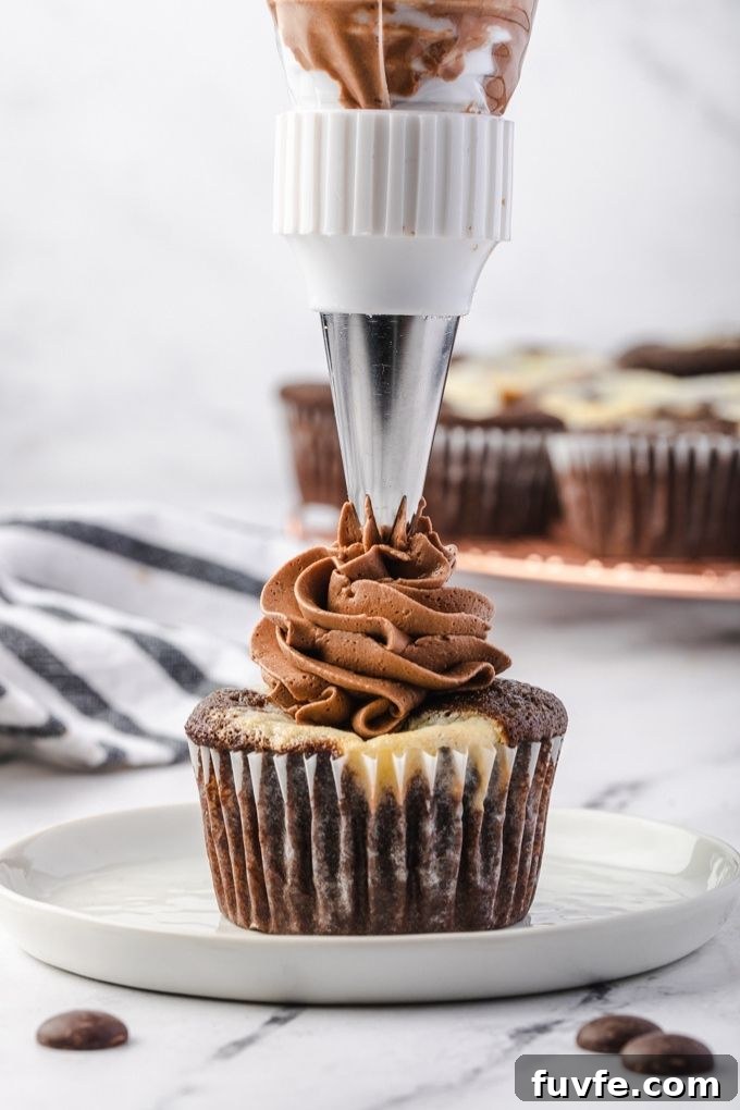 Chocolate buttercream frosting piped onto a black bottom cupcake