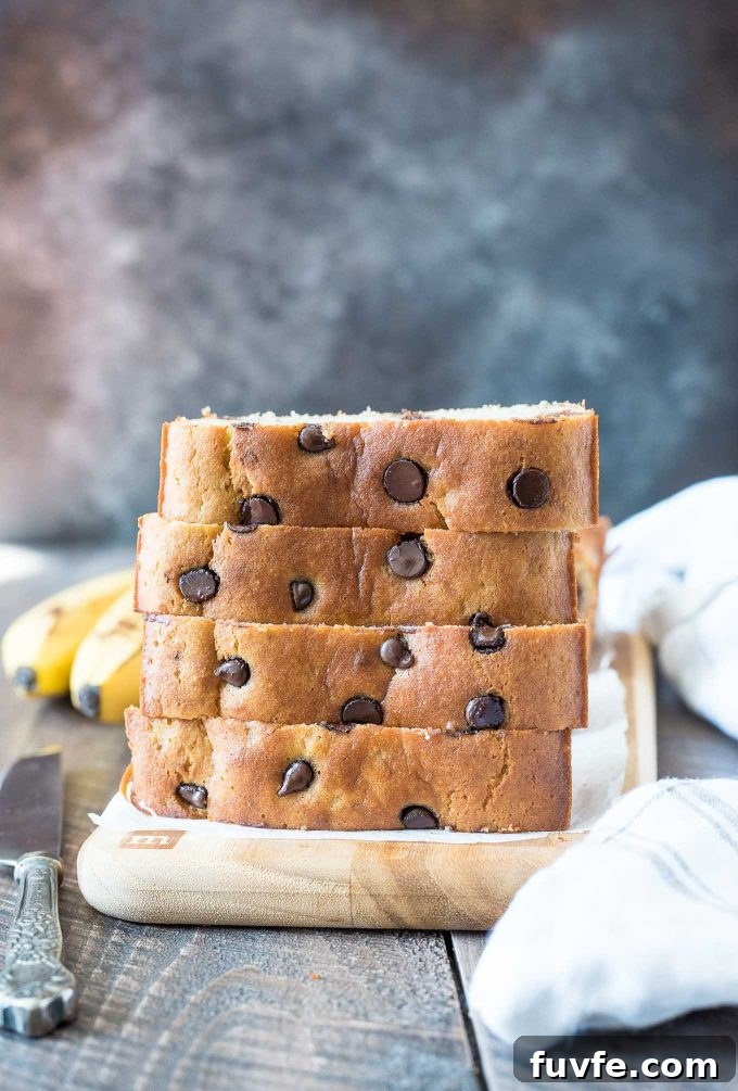 Gluten-Free Almond Flour Banana Bread Recipe 2 Slices of almond flour banana bread stacked on a cutting board.