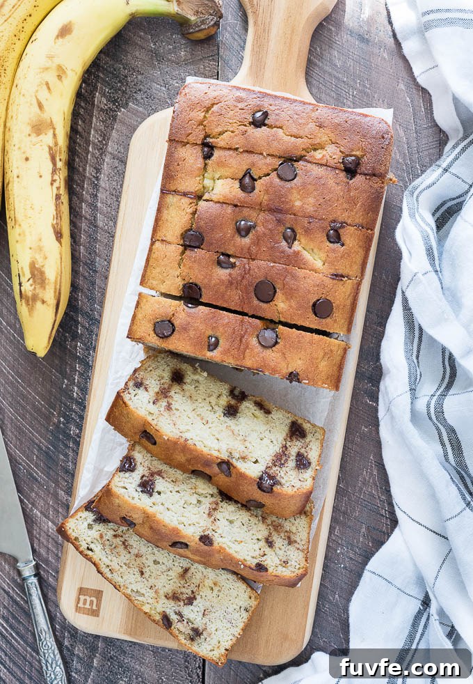 Moist almond flour banana bread with chocolate chips sliced on a cutting board.