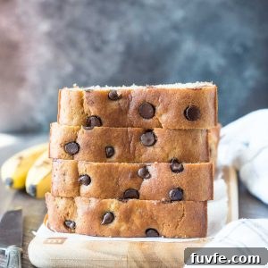 Slices of almond flour banana bread stacked on a cutting board.