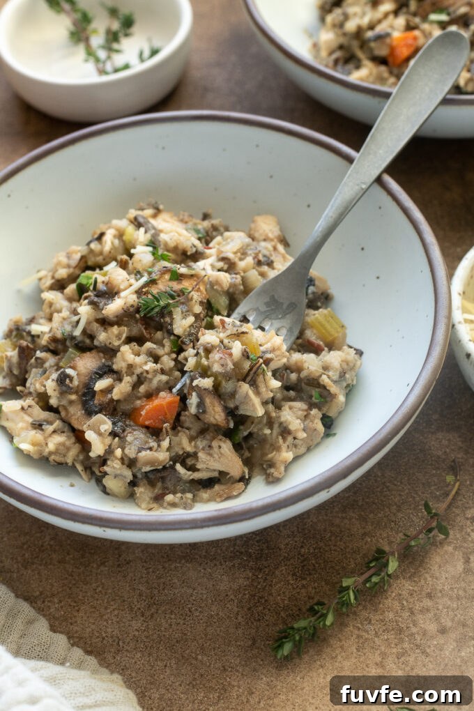Slow Cooker Creamy Chicken and Wild Rice Casserole 8 Crock Pot wild rice casserole with chicken in a bowl.