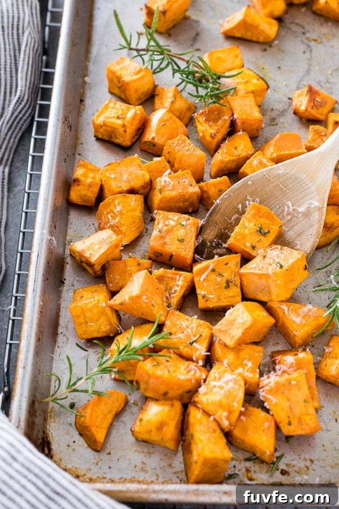 Oven Roasted Sweet Potatoes Recipe with Garlic and Herbs 3 Roasted sweet potatoes on a baking sheet