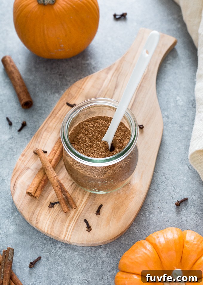 DIY Pumpkin Pie Spice Mix Recipe 6 Spoon buried in a jar of pumpkin spice