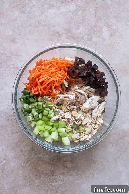 Curry chicken salad ingredients in mixing bowl.