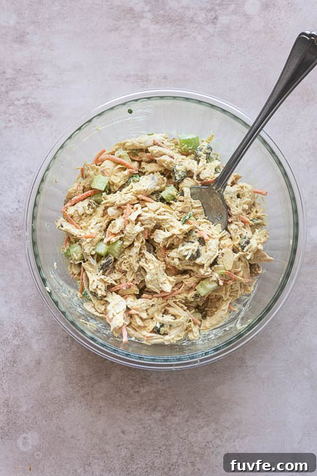 Finished curry chicken salad in a mixing bowl.