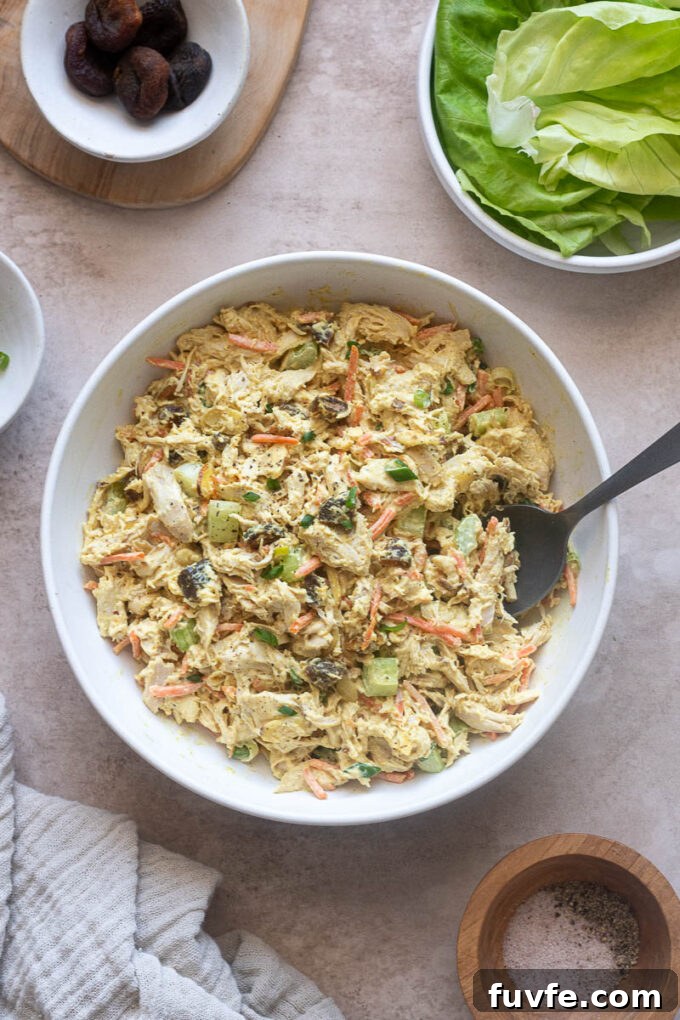 Chicken salad with creamy curry dressing in a white serving bowl.