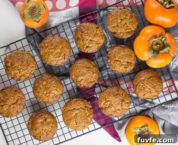 Overhead view of persimmon muffins on a wire cooling rack.