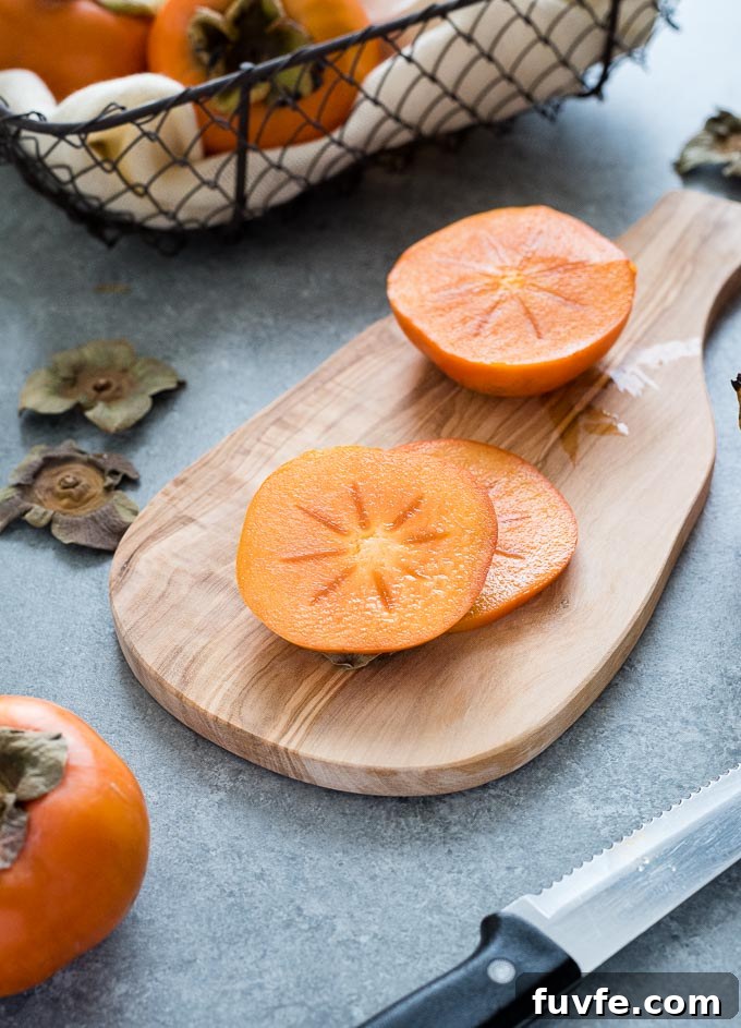 Slices of fuyu persimmon on a cutting board