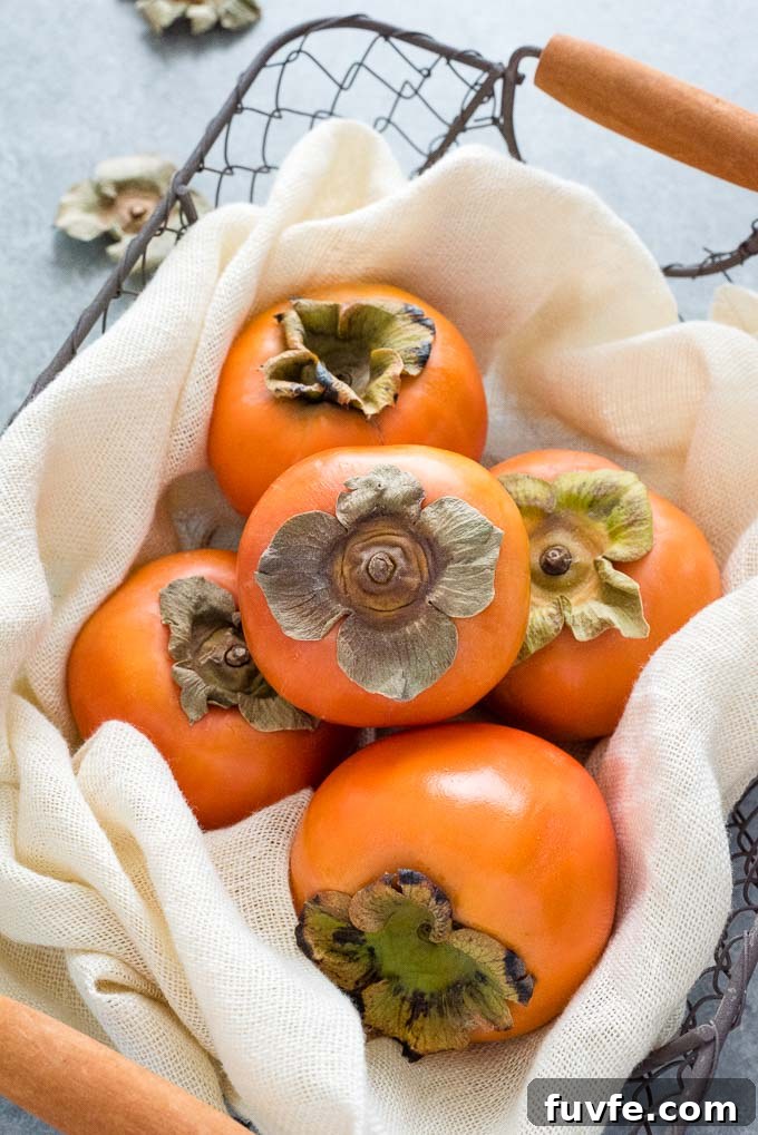 Fuyu persimmons in a wire basket