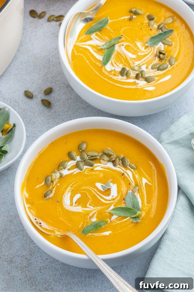 Roasted Pumpkin and Apple Soup with Warm Spices 3 Bowls of roasted pumpkin apple soup with a spoon digging in