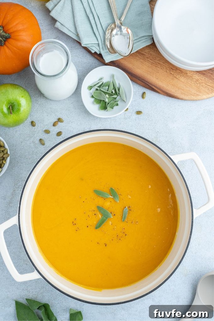 Roasted Pumpkin and Apple Soup with Warm Spices 6 Pot of roasted pumpkin apple soup with sage on top