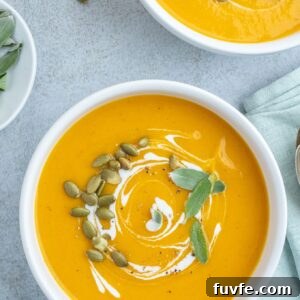 Roasted Pumpkin and Apple Soup with Warm Spices 9 Roasted pumpkin soup in bowls with coconut milk and sage