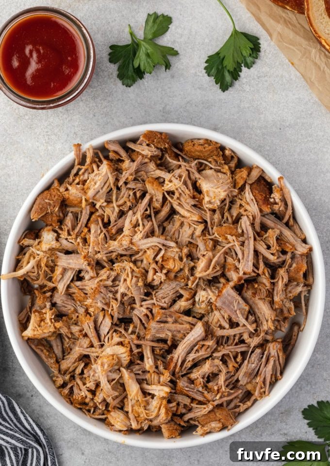 Tender Smoky Instant Pot Pulled Pork with Tangy BBQ Sauce 2 Instant pot pulled pork in a white bowl