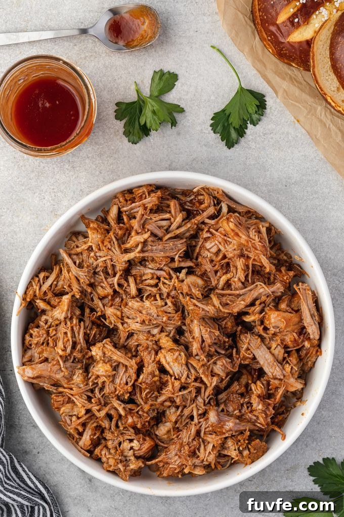 Tender Smoky Instant Pot Pulled Pork with Tangy BBQ Sauce 7 Instant Pot pulled pork with bbq sauce in a bowl