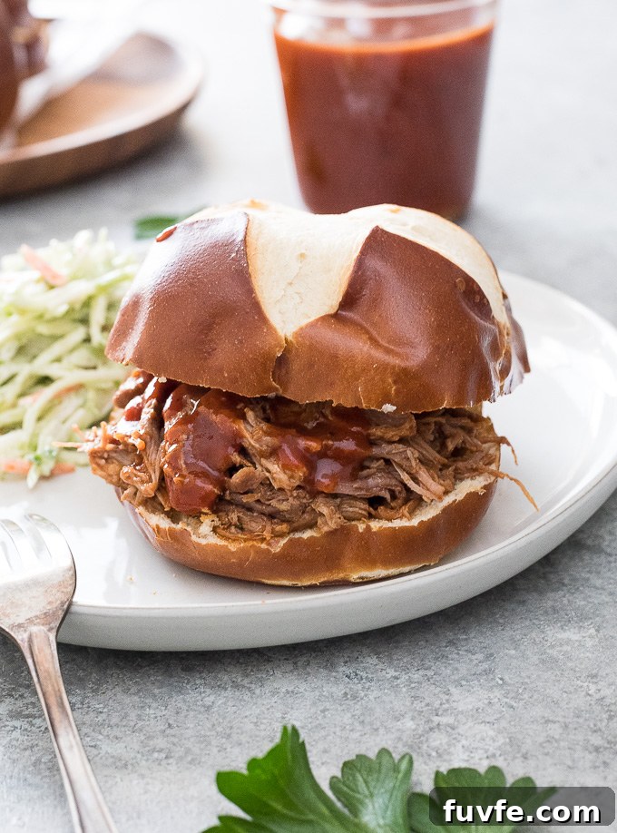Tender Smoky Instant Pot Pulled Pork with Tangy BBQ Sauce 8 Instant Pot pulled pork in a bun with broccoli slaw