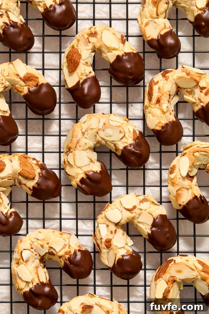 Chocolate-Dipped Almond Horn Cookies 11 Chocolate dipped almond horn cookies on a wire rack.