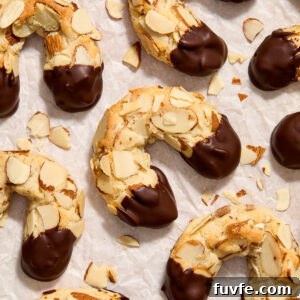 Almond horn cookies on parchment paper.