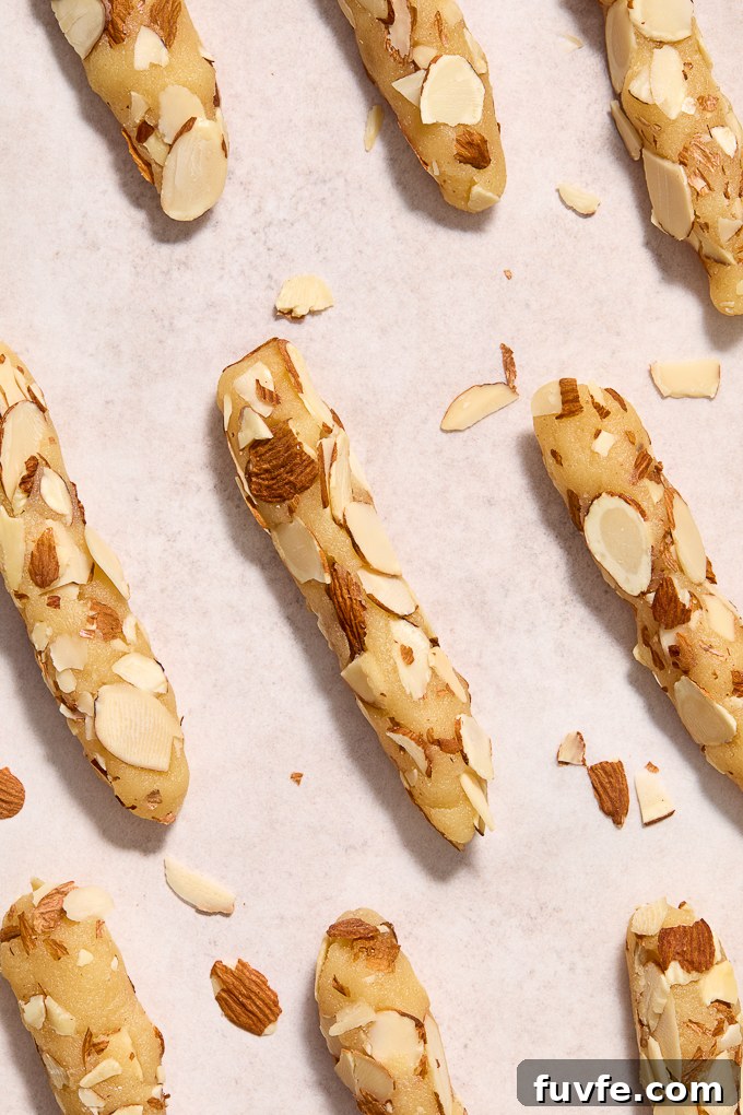Chocolate-Dipped Almond Horn Cookies 6 Almond horn cookies rolled into logs with almonds.