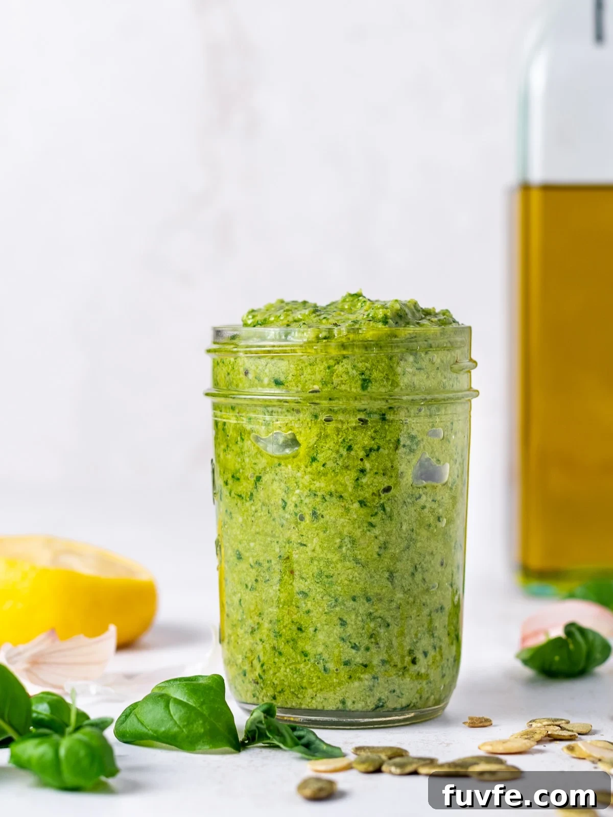 Pepita Pesto Recipe: Nutty Pumpkin Seed Sauce for Pasta & Toast 2 jar of pesto with basil leaves, half a lemon, garlic papers and pumpkin seeds