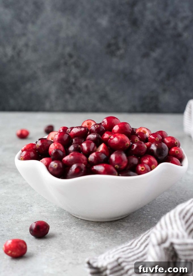 White bowl filled with fresh cranberries