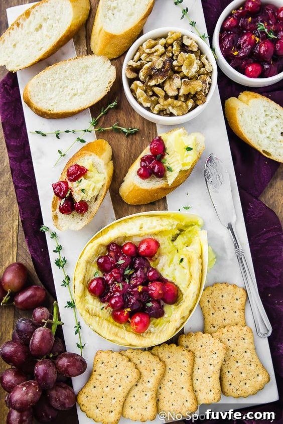 Overhead view of baked camembert on a white platter.