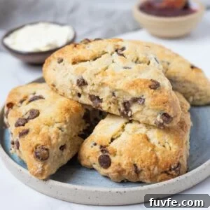 15 Irresistible Chocolate Sourdough Recipes to Try Today 15 Close up of golden sourdough chocolate chip scones stacked on a plate.