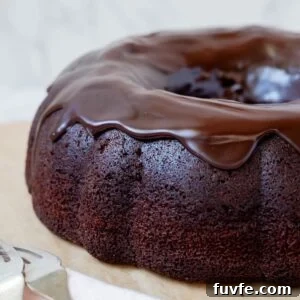 15 Irresistible Chocolate Sourdough Recipes to Try Today 31 Close up of sourdough chocolate bundt cake topped with glossy chocolate ganache.