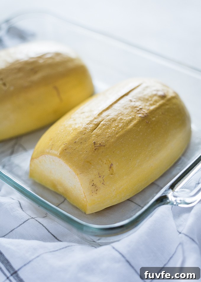 Halved spaghetti squash in baking dish