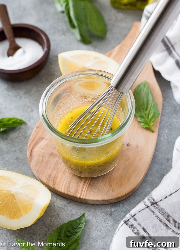 Jar of homemade Italian salad dressing with whisk