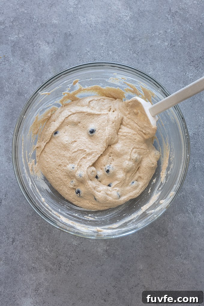 Greek yogurt pancake recipe batter with blueberries folded in.
