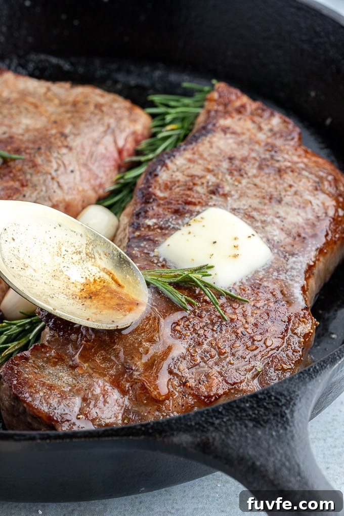 Pan-Seared Steak Recipe with Garlic Butter 6 Butter basted steak in a cast iron skillet