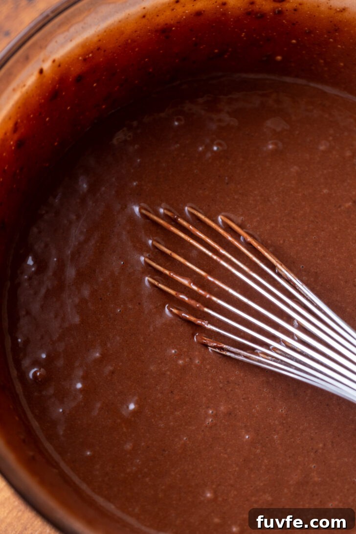 Decadent Chocolate Caramel Cake Recipe for Special Occasions 4 Chocolate cake batter in a bowl.