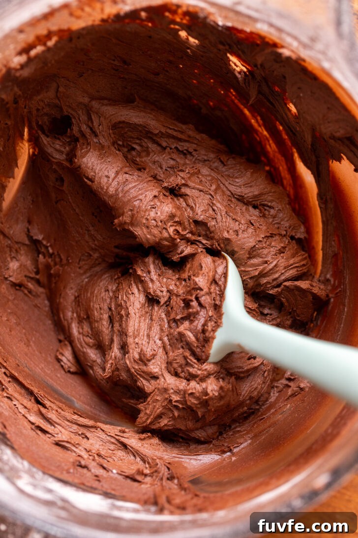 Decadent Chocolate Caramel Cake Recipe for Special Occasions 6 Chocolate frosting in a bowl.