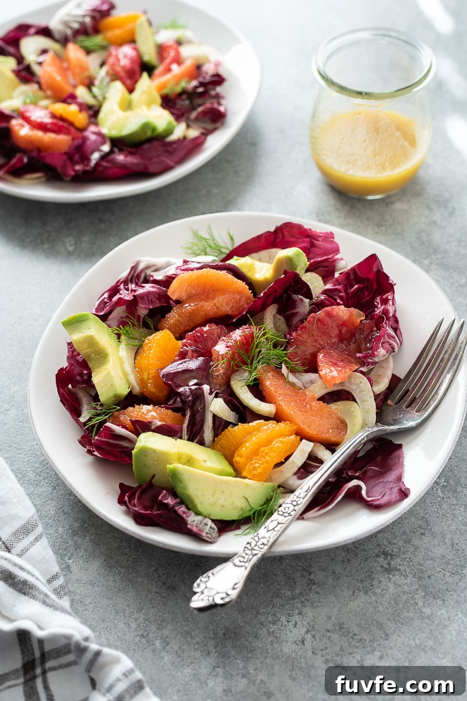 Radicchio salad on a white plate with a fork