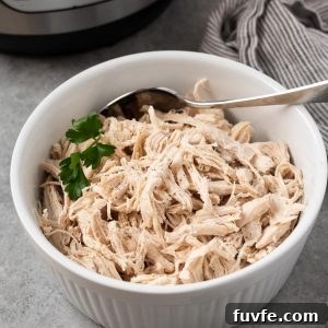 How to Make Shredded Chicken in the Instant Pot 8 Instant Pot shredded chicken in a white dish with parsley