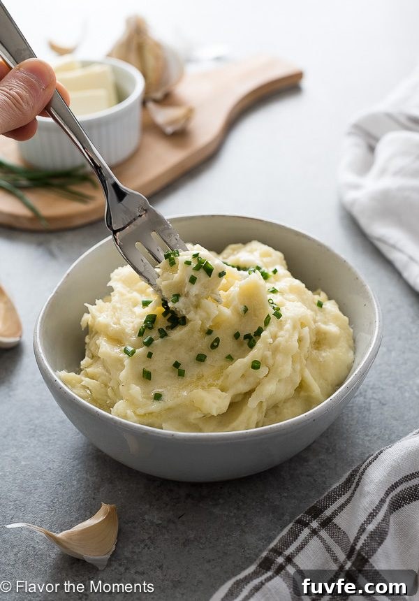 Fork buried in center of serving of instant pot mashed potatoes