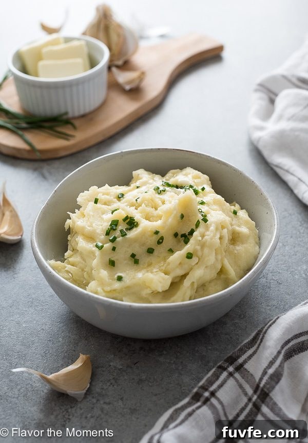 Instant pot mashed potatoes in a bowl with chives and butter on top