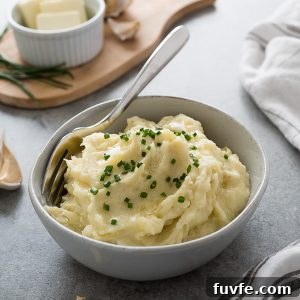Bowl of garlic mashed potatoes topped with chives