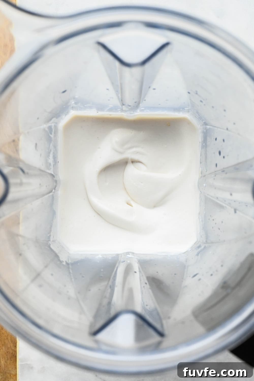 How to make cashew cream: Cashew cream in blender container after blending.