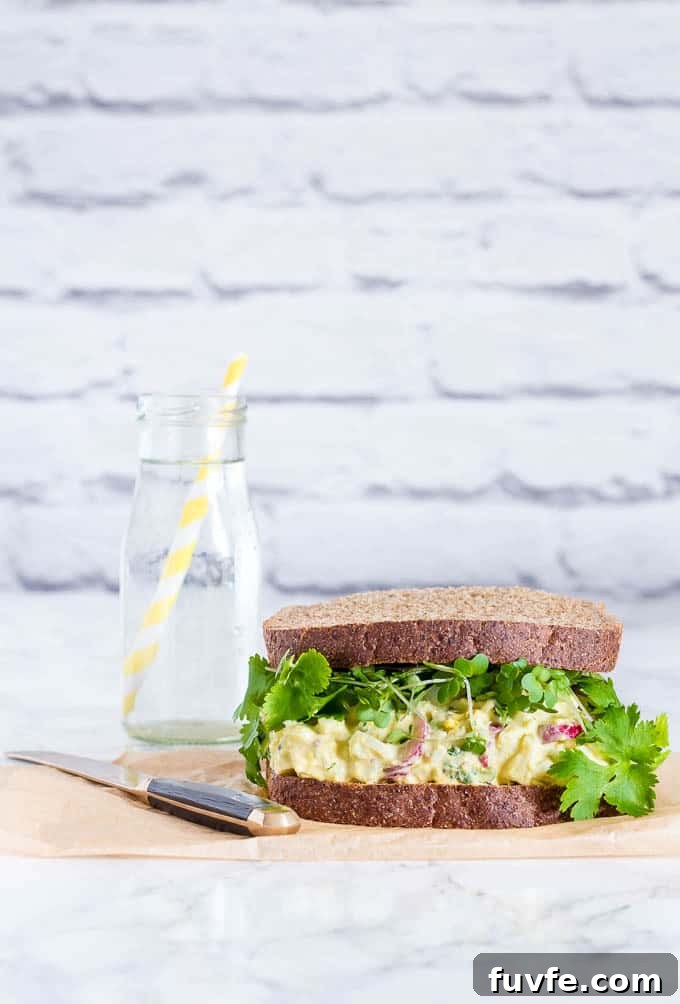 Radish Recipes: Over 20 Ideas and a Produce Guide 12 An egg salad sandwich next to a jug of water.