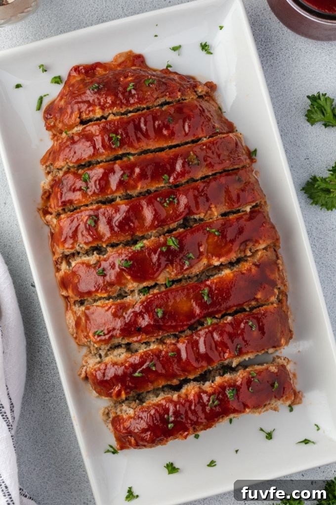Smoky Barbecue Turkey Meatloaf with Oats 6 Sliced bbq turkey meatloaf on a platter with parsley