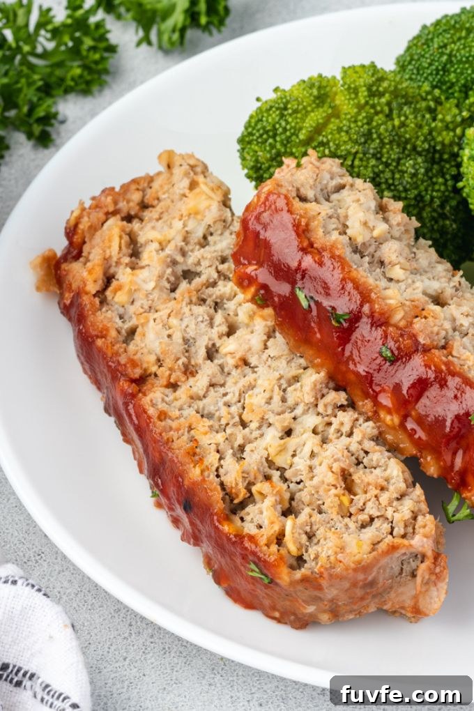 Smoky Barbecue Turkey Meatloaf with Oats 7 Slices of turkey meatloaf with oatmeal on a plate with broccoli