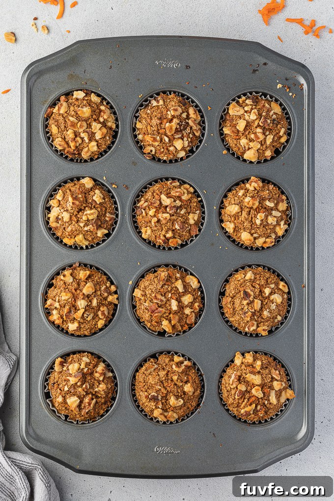 Gluten-free carrot cake muffins in muffin pan.