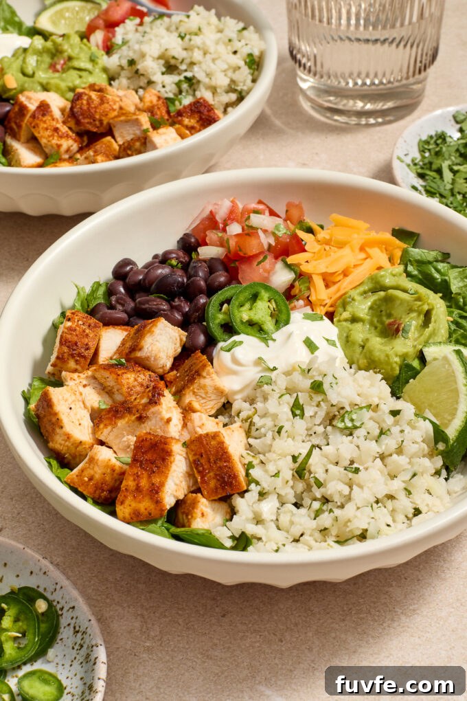 Chicken burrito bowl with cilantro lime cauliflower rice and toppings.