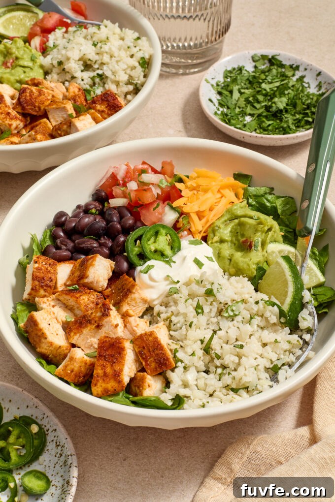 Chicken burrito bowls with fork digging in.