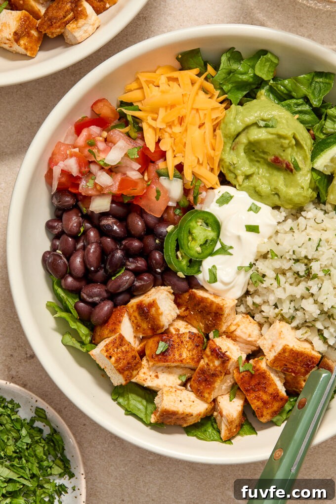 Low carb burrito bowl with chicken, cauliflower rice and toppings.