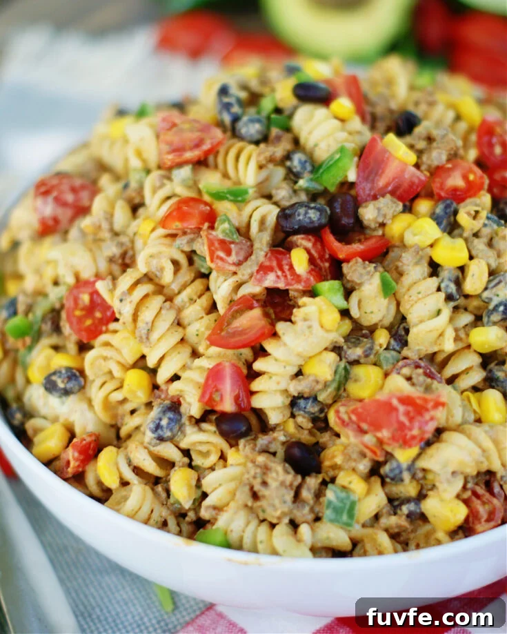 Tex Mex Pasta Salad is loaded with seasoned ground beef, black beans, tomatoes, green onions, corn and jalapenos
